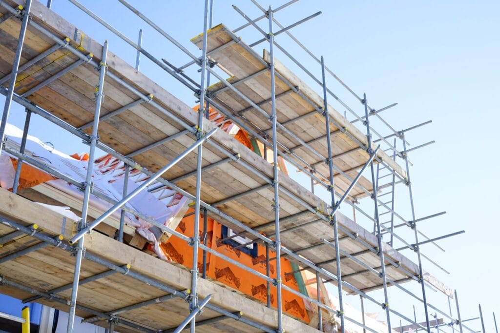 Scaffolding boards and safety rails on house exterior